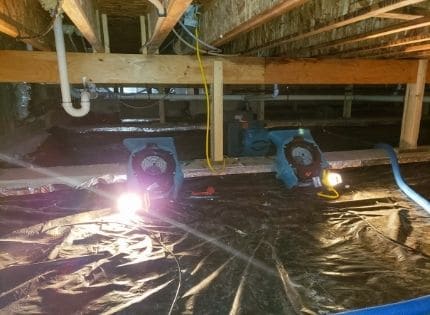 a crawl space with air mover to dry out the structure