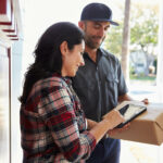 Woman receiving a package from delivery person